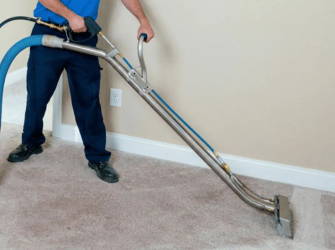 Professional operating a liquid removal machine on a carpeted floor in Hollywood, FL